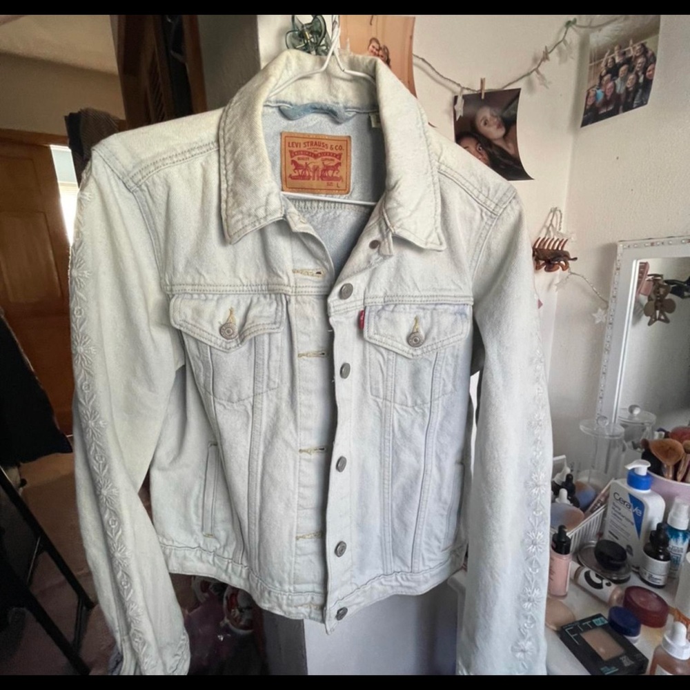 Levi’s light wash with flowers on the arm